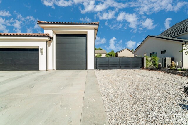 3169 S Pecos Dr, Washington, UT 84780 - garage with a gate, driveway, and fence