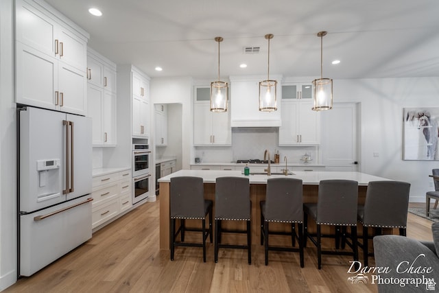 3169 S Pecos Dr, Washington, UT 84780 - kitchen featuring white cabinetry, visible vents, light countertops, and white appliances