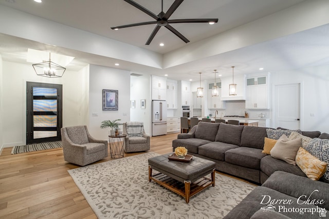 3169 S Pecos Dr, Washington, UT 84780 - living room featuring ceiling fan with notable chandelier, light wood-style floors, and recessed lighting