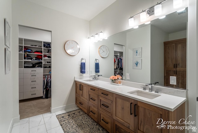 3169 S Pecos Dr, Washington, UT 84780 - full bath with marble finish floor, double vanity, a sink, and baseboards