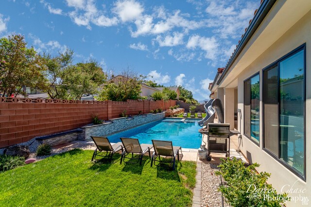 3169 S Pecos Dr, Washington, UT 84780 - view of pool with a fenced in pool, a grill, a water slide, a fenced backyard, and a yard