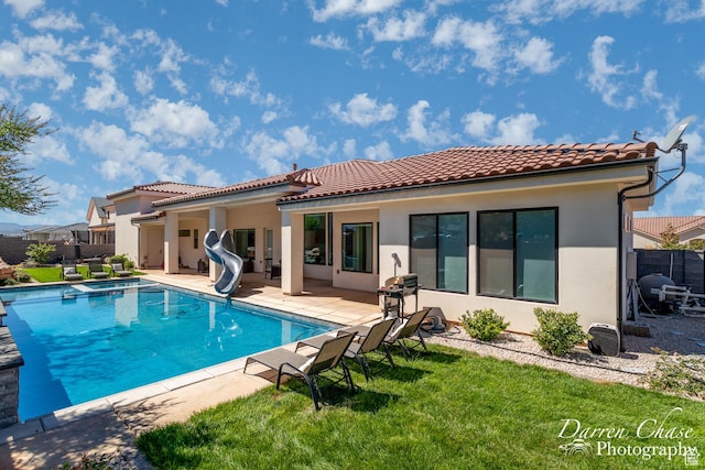 3169 S Pecos Dr, Washington, UT 84780 - back of property featuring a tiled roof, stucco siding, fence, and a patio
