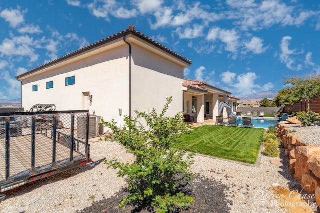 3169 S Pecos Dr, Washington, UT 84780 - rear view of property with fence, a fenced in pool, a tile roof, stucco siding, and a patio area