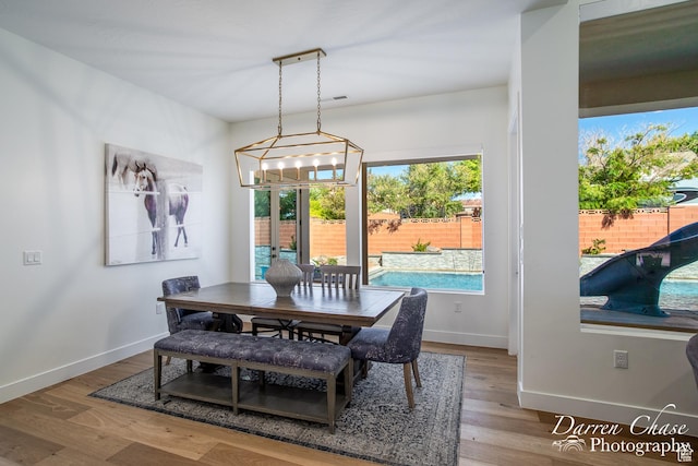 3169 S Pecos Dr, Washington, UT 84780 - dining area with a notable chandelier, baseboards, and wood finished floors