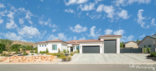 3169 S Pecos Dr, Washington, UT 84780 - mediterranean / spanish-style house with driveway, stucco siding, fence, a tiled roof, and a garage