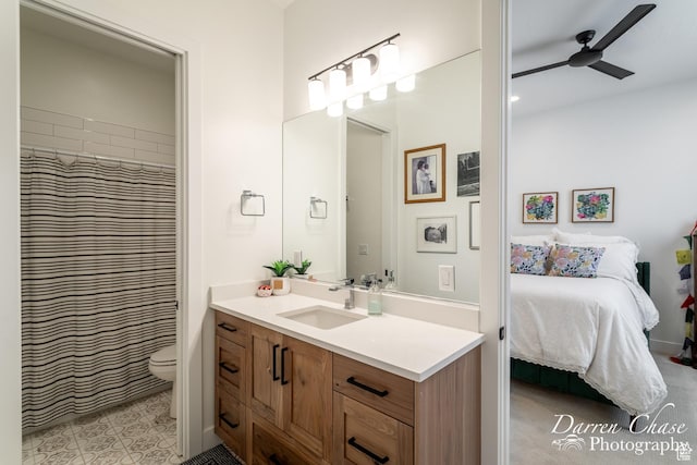 3169 S Pecos Dr, Washington, UT 84780 - bathroom featuring a ceiling fan, vanity, toilet, and ensuite bath