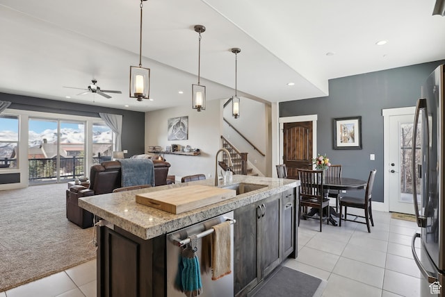 1713 E Viewside Cir, Hideout, UT 84036 - kitchen featuring light tile patterned flooring, light carpet, open floor plan, stainless steel appliances, and dark brown cabinets