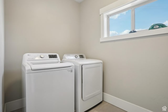 1713 E Viewside Cir, Hideout, UT 84036 - washroom featuring baseboards, light tile patterned floors, laundry area, and washer and clothes dryer
