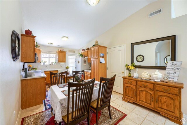 2050 W Canyon View Dr Unit 203, St George, UT 84770 - dining space with lofted ceiling, visible vents, and light tile patterned floors