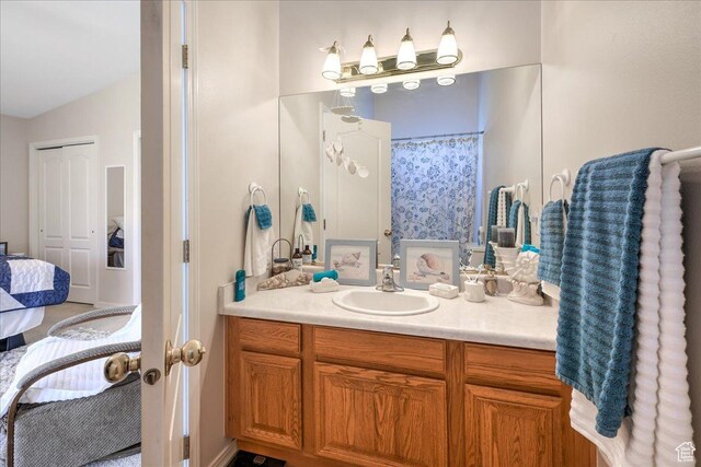 2050 W Canyon View Dr Unit 203, St George, UT 84770 - bathroom featuring connected bathroom, vaulted ceiling, and vanity
