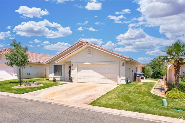 2050 W Canyon View Dr Unit 203, St George, UT 84770 - view of front facade featuring a front lawn, driveway, stucco siding, and a garage