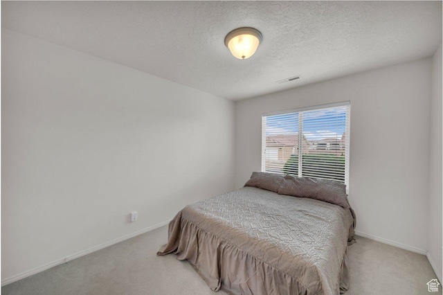 547 E Oasis Dr, Ivins, UT 84738 - carpeted bedroom with baseboards, a textured ceiling, and visible vents