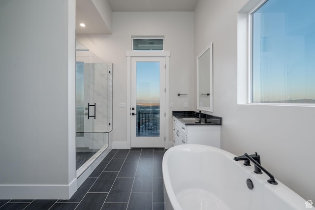 850 S Finley Cir Unit 239, North Salt Lake, UT 84054 - bathroom with a stall shower, a freestanding bath, vanity, baseboards, and recessed lighting