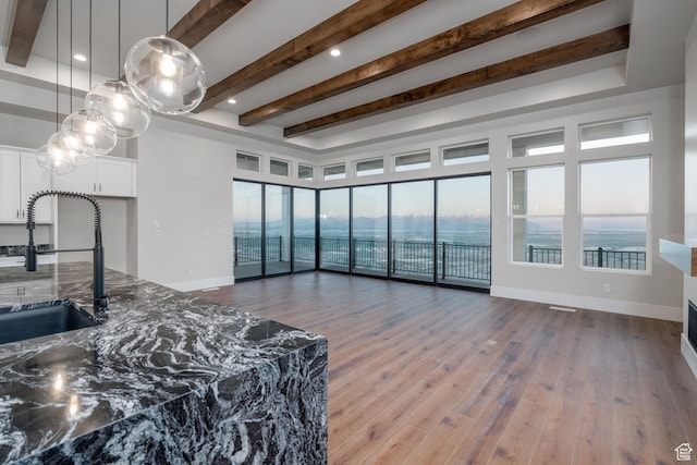 850 S Finley Cir Unit 239, North Salt Lake, UT 84054 - living room featuring wood finished floors, beam ceiling, baseboards, healthy amount of natural light, and recessed lighting