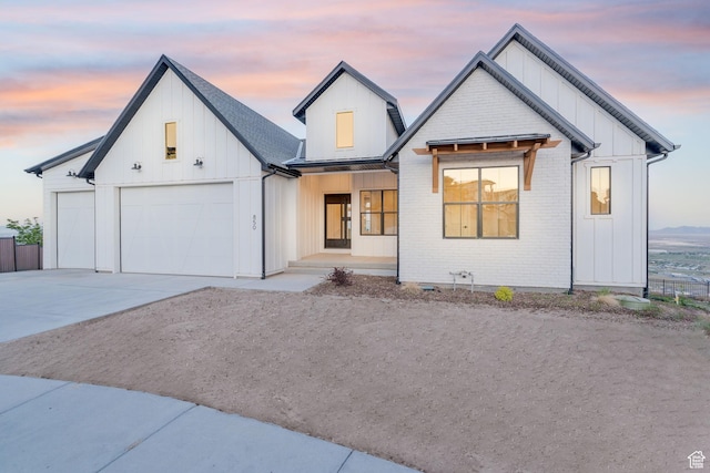 850 S Finley Cir Unit 239, North Salt Lake, UT 84054 - modern farmhouse style home featuring covered porch, concrete driveway, an attached garage, board and batten siding, and fence