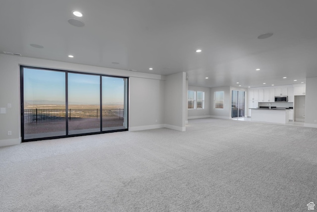 850 S Finley Cir Unit 239, North Salt Lake, UT 84054 - unfurnished living room with baseboards, recessed lighting, and light carpet