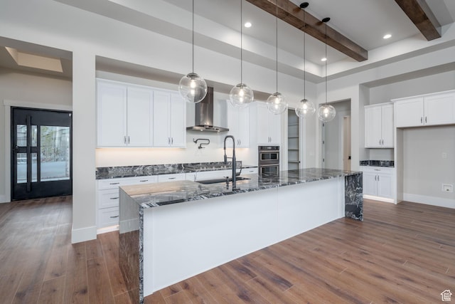 850 S Finley Cir Unit 239, North Salt Lake, UT 84054 - kitchen with wall chimney exhaust hood, beamed ceiling, stainless steel oven, dark stone counters, and white cabinetry