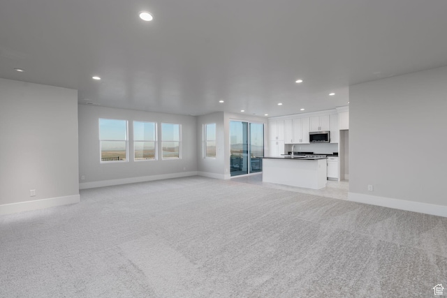 850 S Finley Cir Unit 239, North Salt Lake, UT 84054 - unfurnished living room featuring light colored carpet, recessed lighting, and baseboards