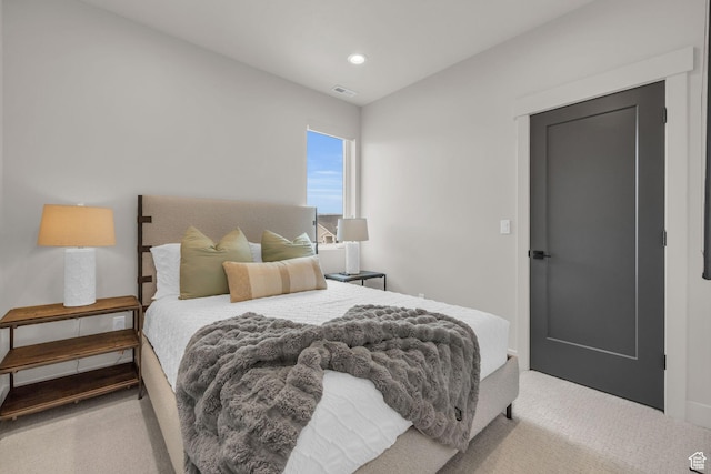 carpeted bedroom with visible vents and recessed lighting