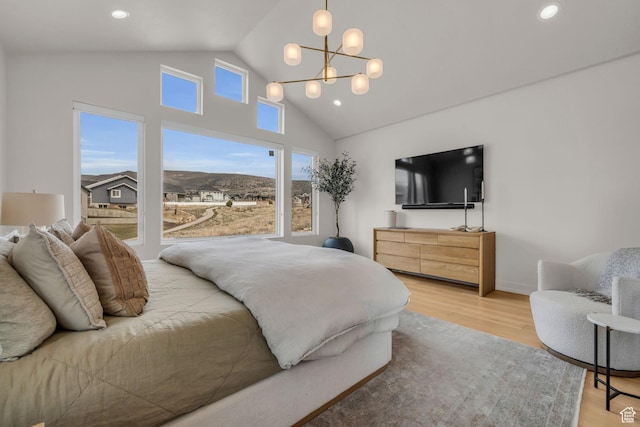 bedroom with recessed lighting, high vaulted ceiling, a chandelier, and wood finished floors