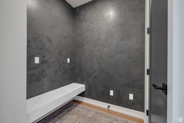 bathroom featuring baseboards and wood finished floors