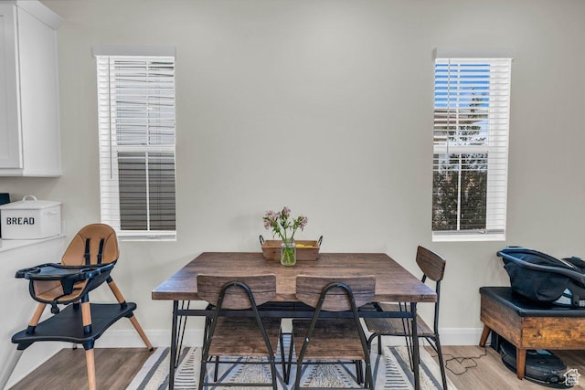 dining room featuring baseboards and light wood-style flooring