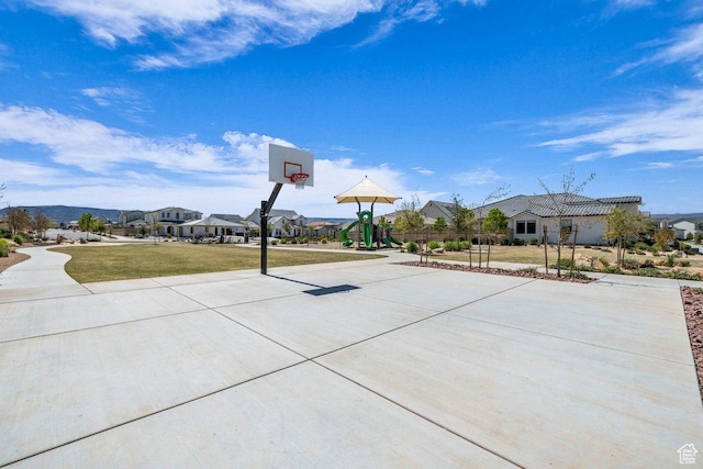 view of sport court with a lawn and community basketball court