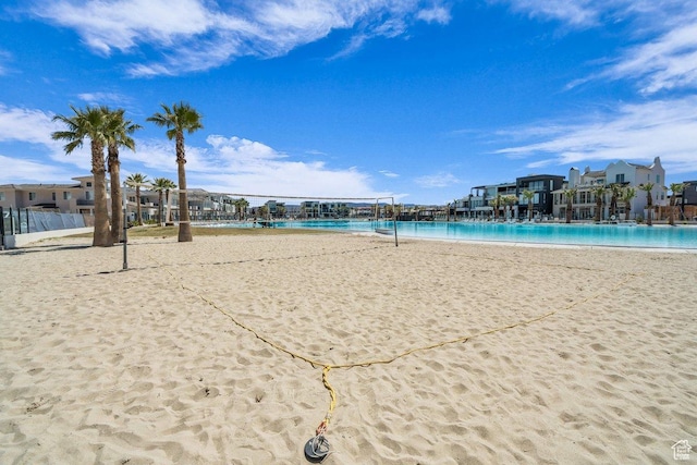 surrounding community with a view of the beach and volleyball court