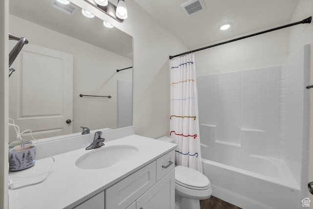 bathroom featuring vanity, visible vents, toilet, and shower / tub combo