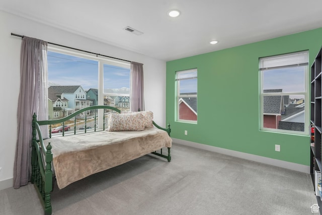 carpeted bedroom featuring baseboards, visible vents, and recessed lighting