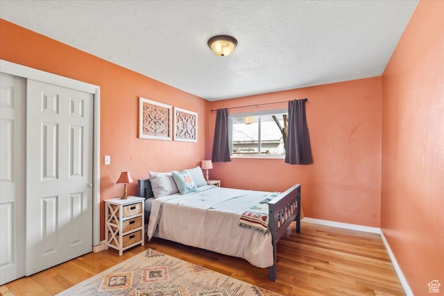 3824 S 500 E, South Salt Lake, UT 84106 - bedroom featuring light wood finished floors, baseboards, and a textured ceiling