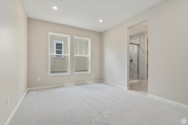 unfurnished bedroom featuring connected bathroom, carpet, baseboards, visible vents, and recessed lighting