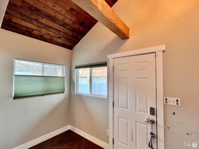 interior space featuring baseboards and vaulted ceiling with beams