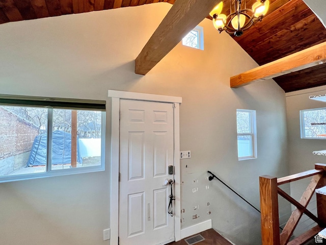 foyer with high vaulted ceiling, visible vents, baseboards, beam ceiling, and a notable chandelier