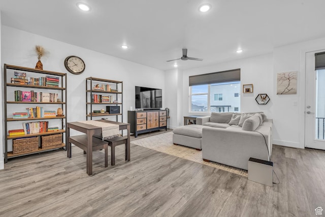 living room with a ceiling fan, recessed lighting, baseboards, and wood finished floors