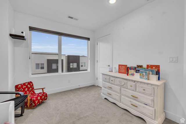 living area featuring light carpet, baseboards, and visible vents