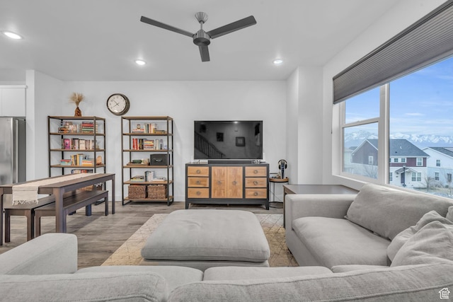living room featuring a ceiling fan, recessed lighting, and wood finished floors