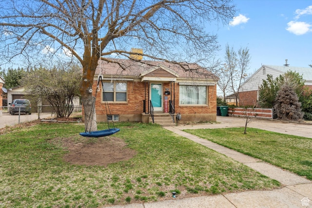 5482 S 2200 W, Roy, UT 84067 - bungalow-style house with a chimney, a front yard, fence, and brick siding