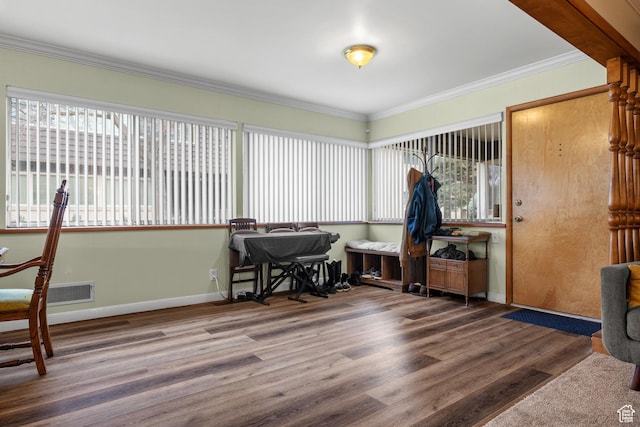 office featuring baseboards, a wealth of natural light, wood finished floors, and crown molding