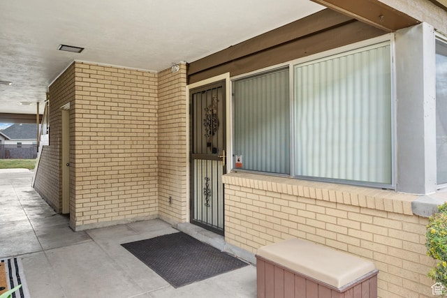 property entrance with brick siding