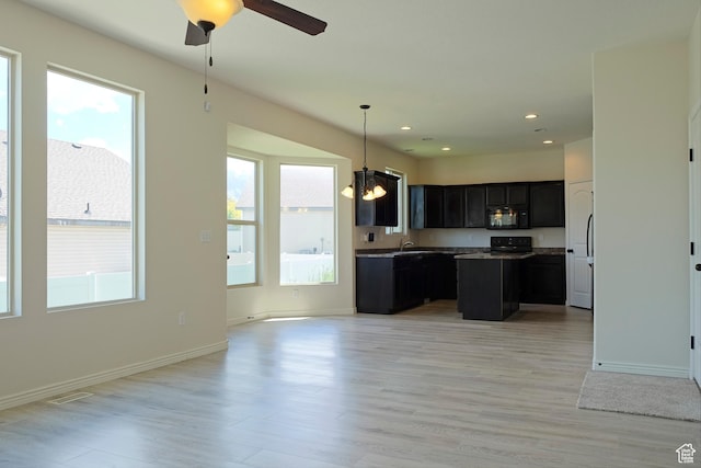 918 N Gypsum Dr, Tooele, UT 84074 - kitchen featuring black microwave, open floor plan, ceiling fan, and a healthy amount of sunlight