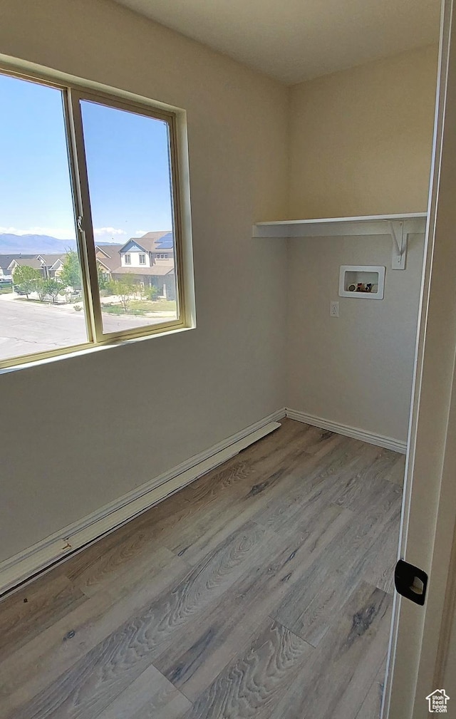 918 N Gypsum Dr, Tooele, UT 84074 - clothes washing area featuring washer hookup, baseboard heating, baseboards, laundry area, and wood finished floors
