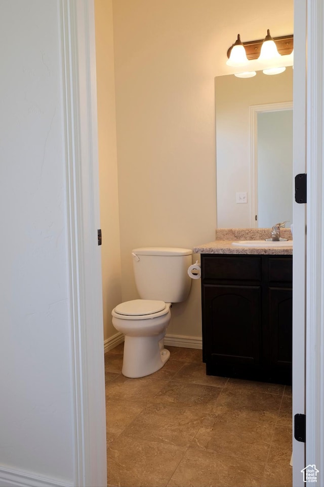 918 N Gypsum Dr, Tooele, UT 84074 - bathroom with baseboards, toilet, and vanity