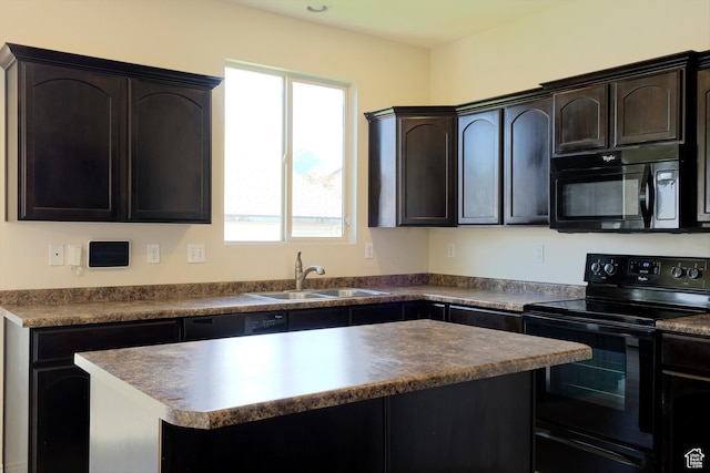 918 N Gypsum Dr, Tooele, UT 84074 - kitchen with a sink, black appliances, dark countertops, and a kitchen island