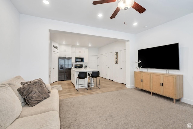 2740 E Kistler Aly, Eagle Mountain, UT 84005 - living area featuring baseboards, light colored carpet, light wood-style floors, ceiling fan, and recessed lighting