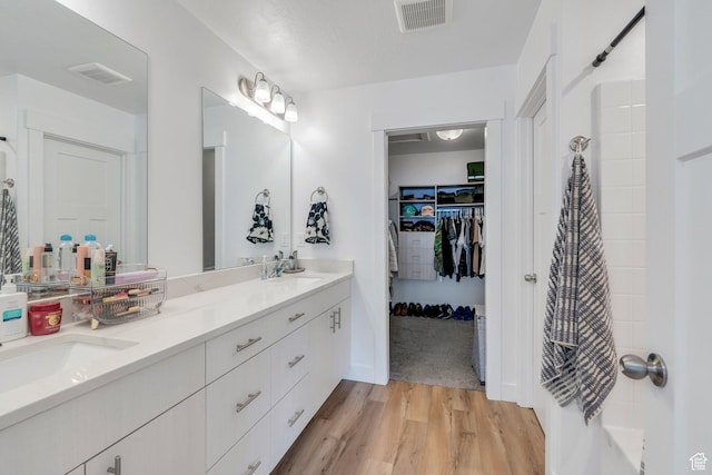 2740 E Kistler Aly, Eagle Mountain, UT 84005 - bathroom featuring a sink, double vanity, visible vents, and wood finished floors