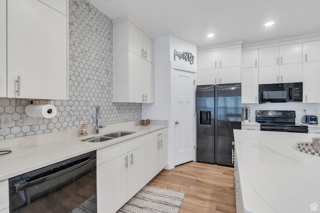 2740 E Kistler Aly, Eagle Mountain, UT 84005 - kitchen with white cabinetry, a sink, black appliances, and light wood-type flooring