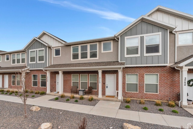 2740 E Kistler Aly, Eagle Mountain, UT 84005 - view of property featuring covered porch, board and batten siding, and brick siding