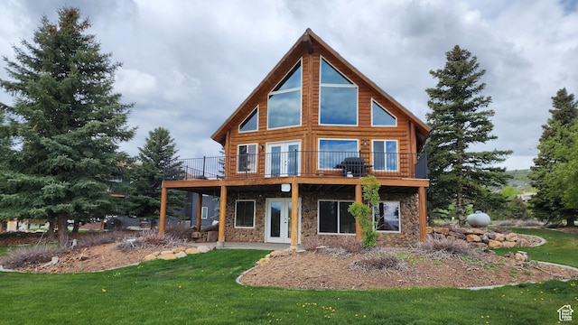 2568 Foxridge Dr, Garden City, UT 84028 - back of house featuring stone siding, a yard, and a deck