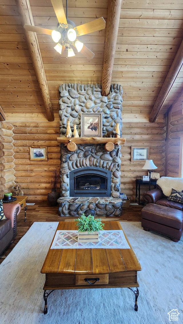 2568 Foxridge Dr, Garden City, UT 84028 - living room with beam ceiling, log walls, wood ceiling, wood finished floors, and a stone fireplace